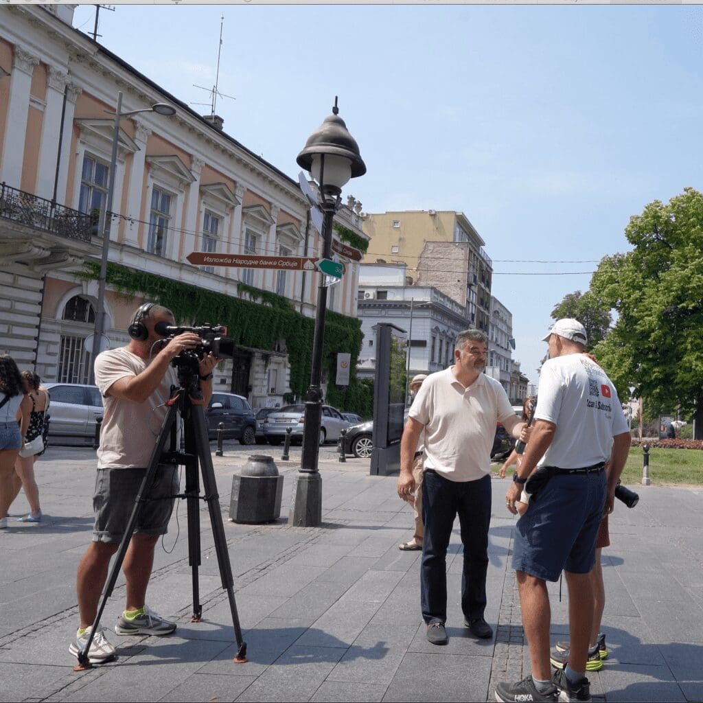 John and Bev, Retirement Travelers being interviewed on Serbian TV