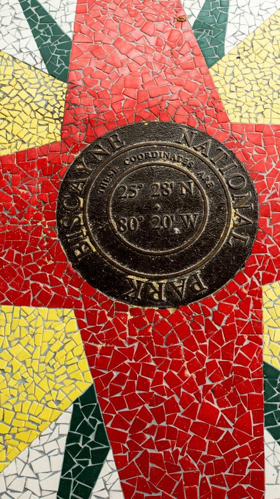 red and yellow tile floor with a brass marker that reads Biscayne National Park