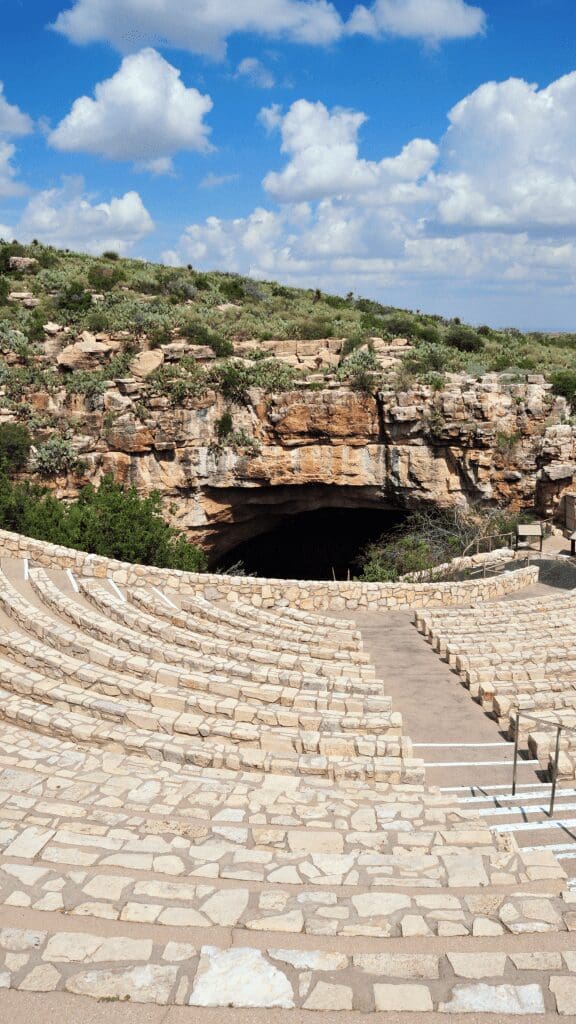 seating of amphitheater and entrance to cave