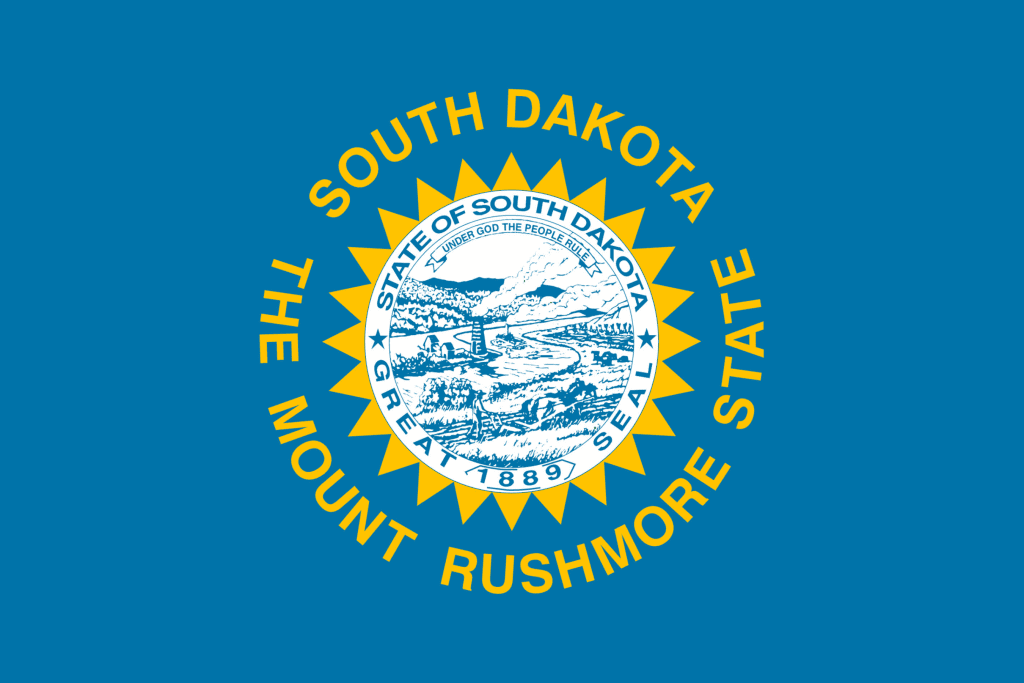 a blue flag with writing and a picture in the middle of a circle. The South Dakota Flag, which is home to Badlands