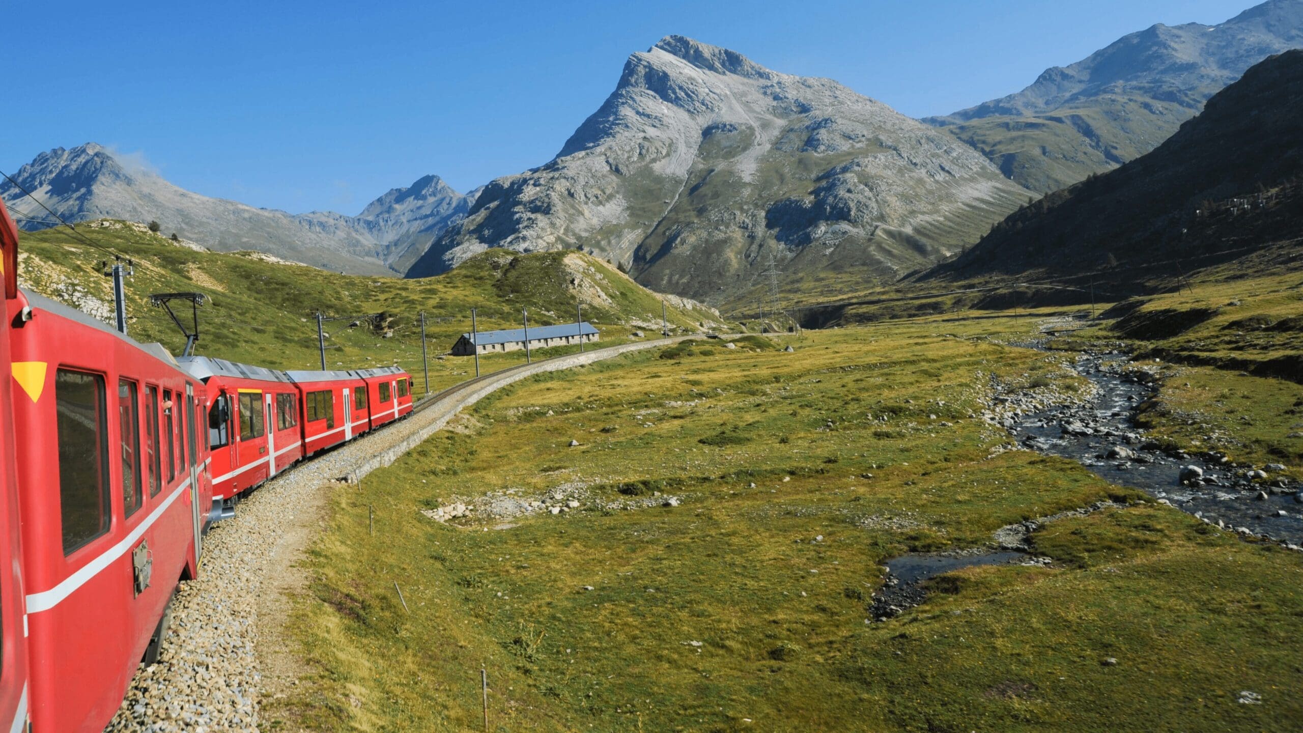 red train going through mountains