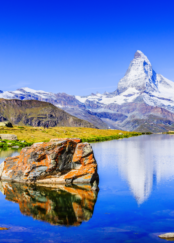 matterhorn in background covered in snow and lake in foreground
