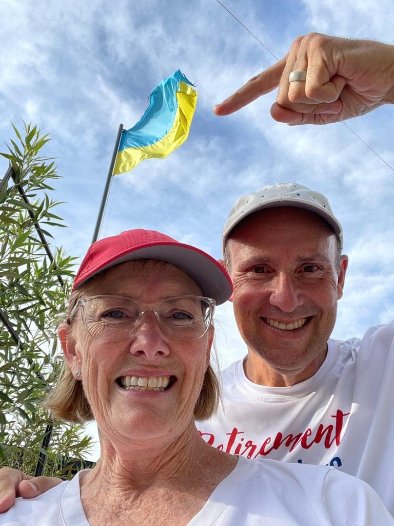 Bev and John pointing to the Ukraine flag