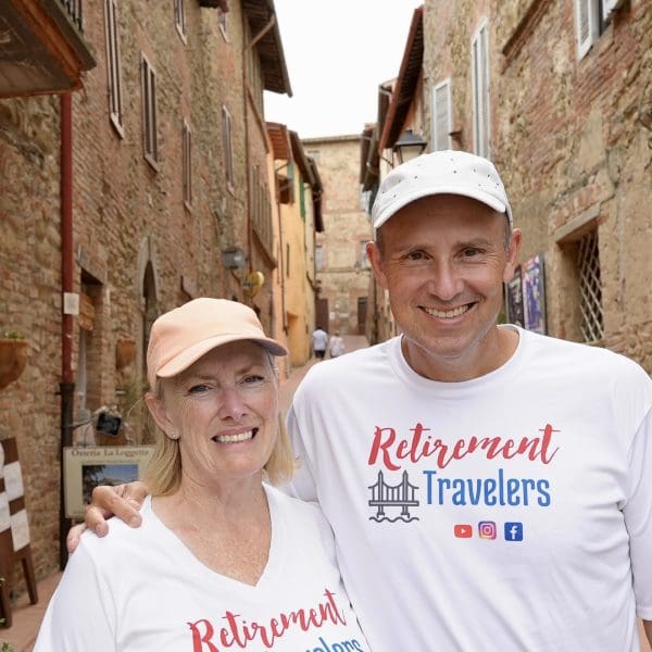 John & Bev standing in an ally in umbria, italy surrounded by stone buildings