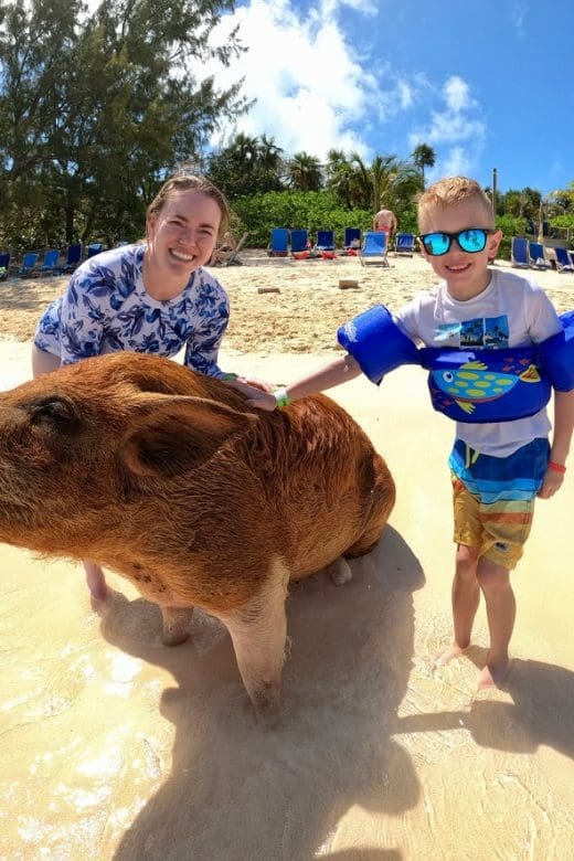 Swimming pigs of the bahamas with girl and boy