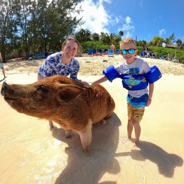 Swimming pigs of the bahamas with girl and boy