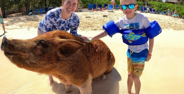 Swimming pigs of the bahamas with girl and boy