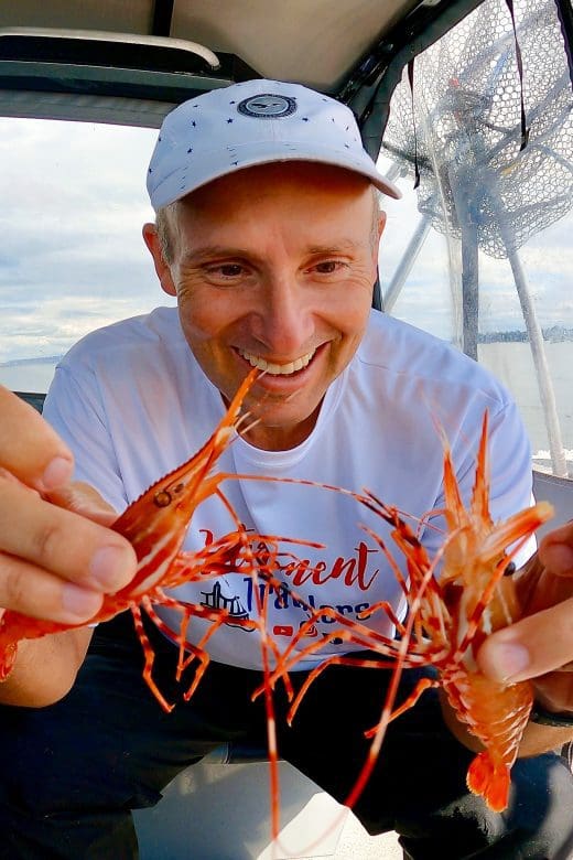 John holding two shrimp in the San Juan Islands