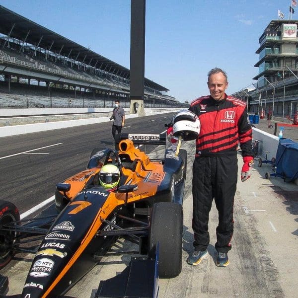 john standing next to car at Indy Racing Experience in Indianapolis