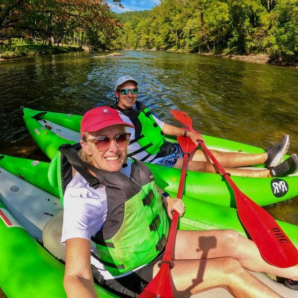 Bev and John on green rafts on Tuckasegee River in Sylva, North Carolina