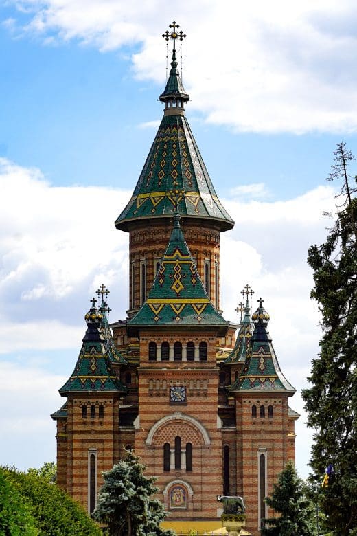picture of vertical church with green tile roof and round spires