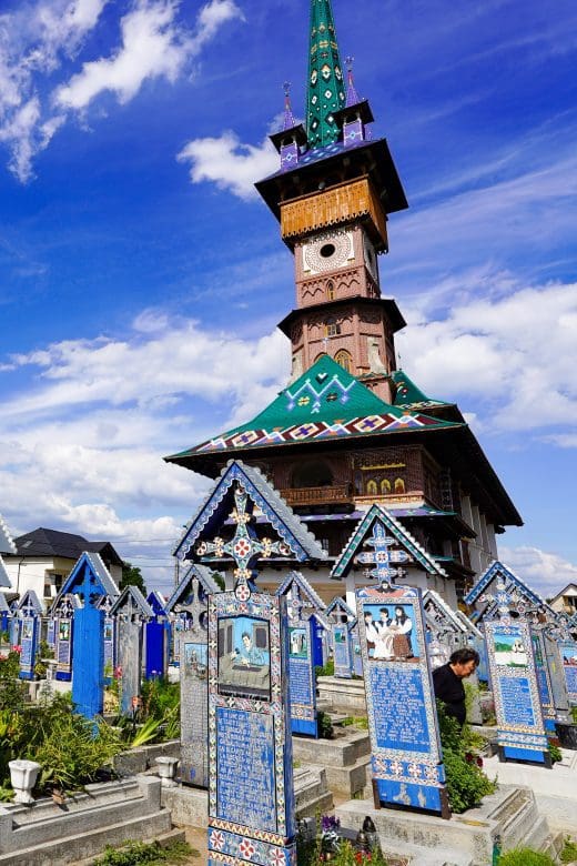The Merry Cemetery in Romanian church surrounded by blue wooden tombstones that are handpainted in romania