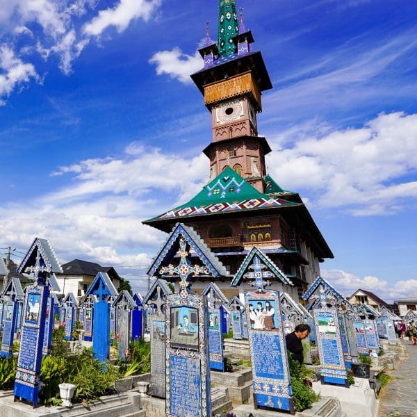 The Merry Cemetery in Romanian church surrounded by blue wooden tombstones that are handpainted in romania