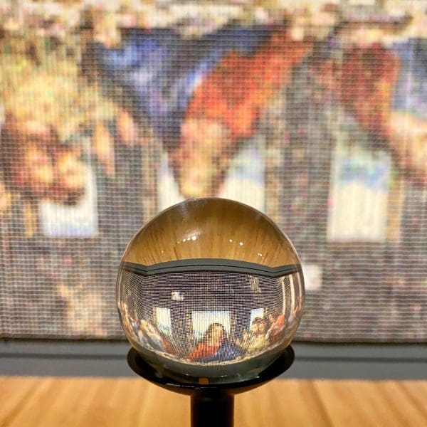Crystal Bridges museum picture of spool scene with round crystal and the last supper projected through it