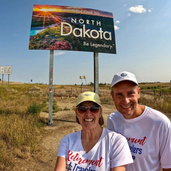 John & Bev in front of North Dakota sign