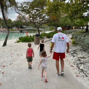 man walking with his grandkids on a trail in the Bahamas