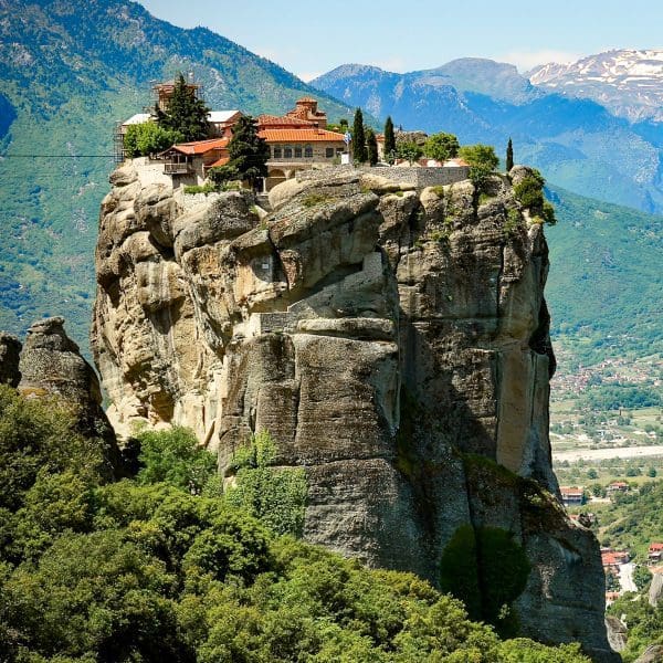 a monastery on a rock formation high above the city