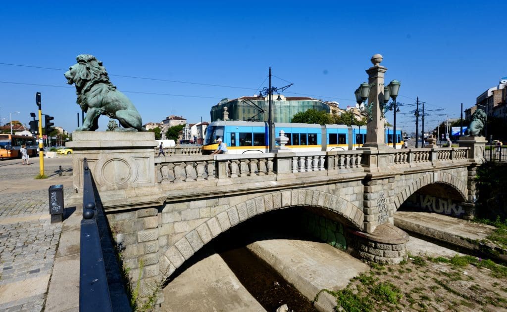 a bridge with huge bronze lions