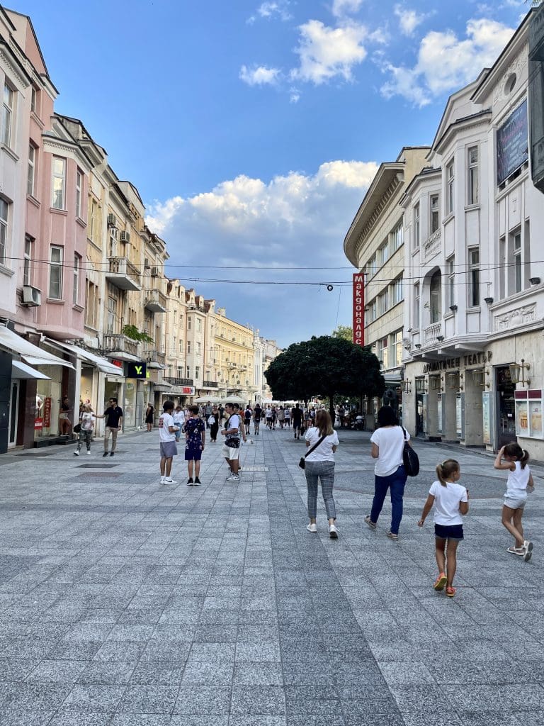 a large street with people walking