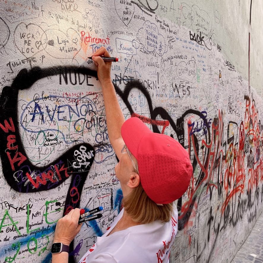 bev writing our name on the wall of the city