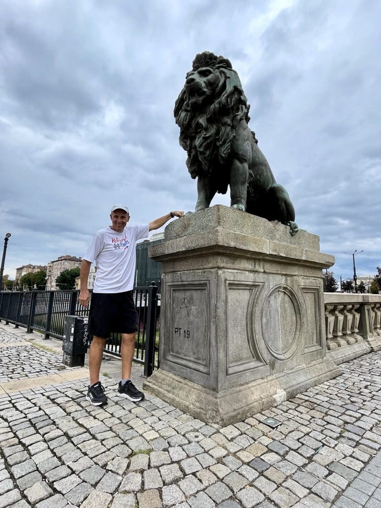 john standing by end statue