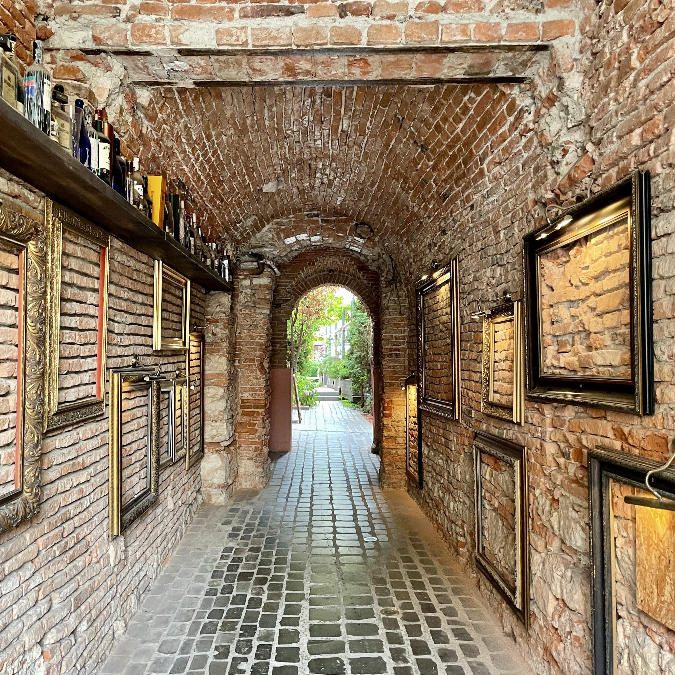 brick alleyway with picture frames