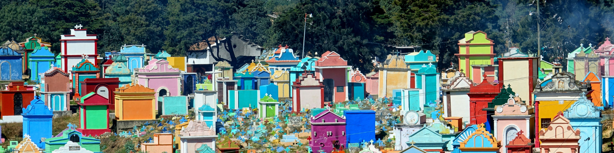 a colorful cemetery in guatemala with painted tombstones