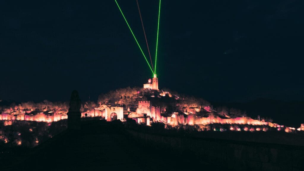 a dark picture with laser show coming from fortress