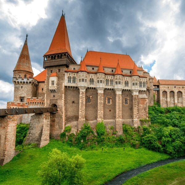 big castle with drawbridge and orange roof