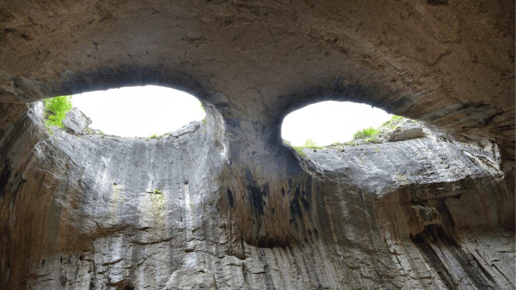 two holes in the ceiling of a cave that look like eyes