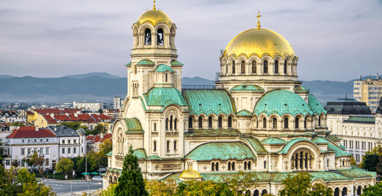 huge cathedral with green roofs and gold domes