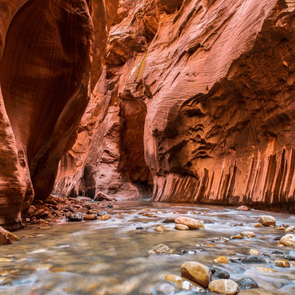 a slot canyon called the narrows that has water running over rocks where people hike through