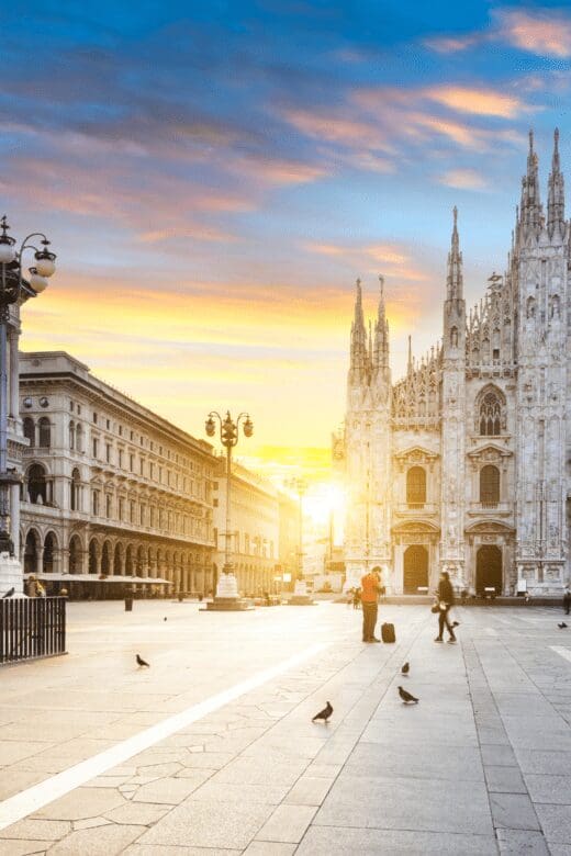 Duomo Cathedral in Milan Italy at sunrise showing the large open square