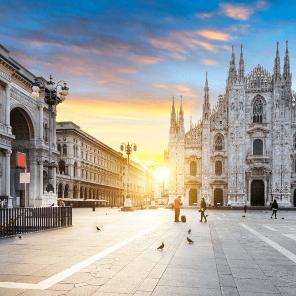 Duomo Cathedral in Milan Italy at sunrise showing the large open square
