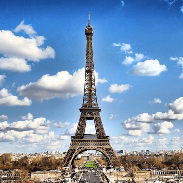 Distant view of the Eiffel Tower in Paris, France with blue skies in the background
