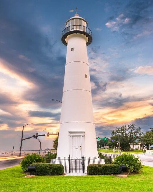 A lighthouse with a beautiful setting sun.