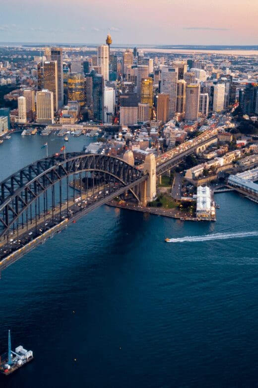 An aerial view of Sydney, Australia, and the Sydney Opera House surrounded by the Pacific Ocean.