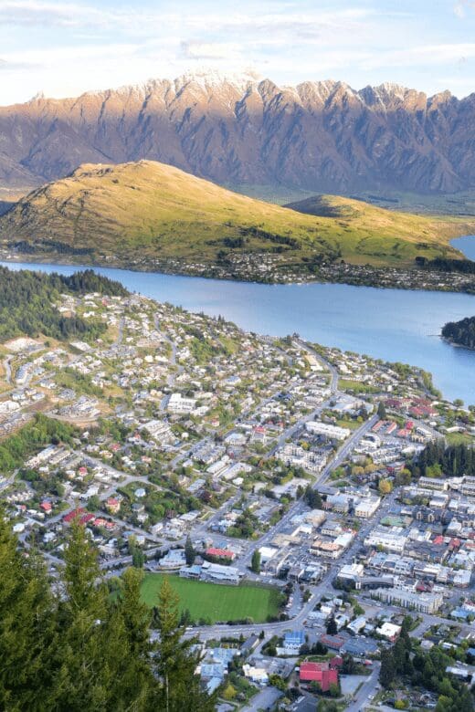 The city of Queenstown, New Zealand surrounded by water and mountainous terrain.