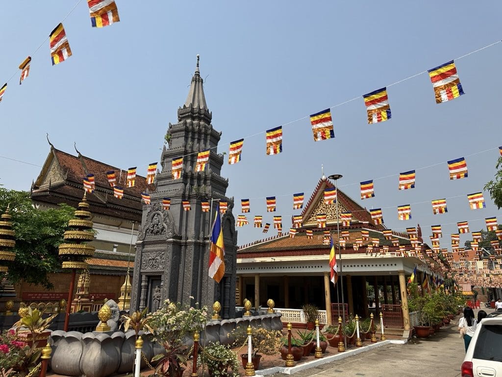 Cambodian city with temples and banners strung above street