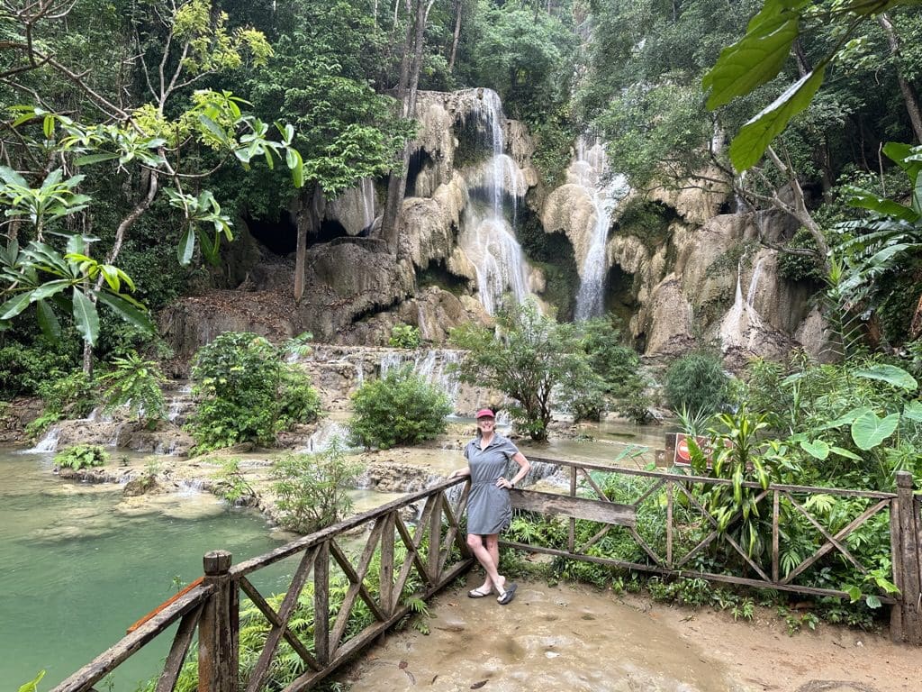 woman standing in front of waterfall in Laos