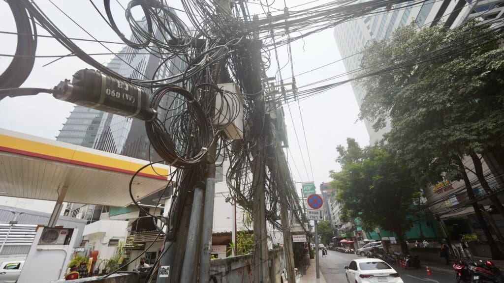 mess of tangled wire on city street poles
