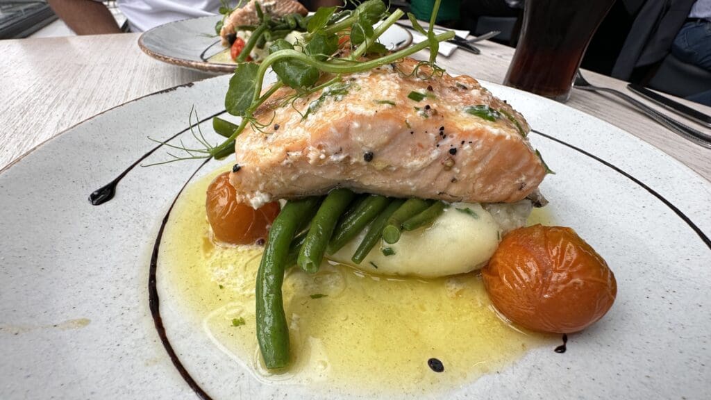 plate with a large filet of salmon on mashed potatoes