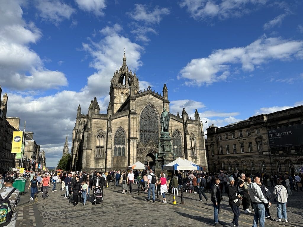 busy pedestrian area in front of church in Edinburgh Scotland
