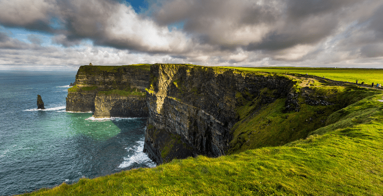 Cliffs of Moher with green grass above and ocean below