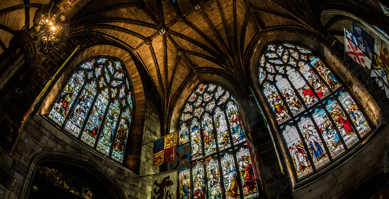 Inside of a large cathedral in Edinburgh showing the beautiful stained glass