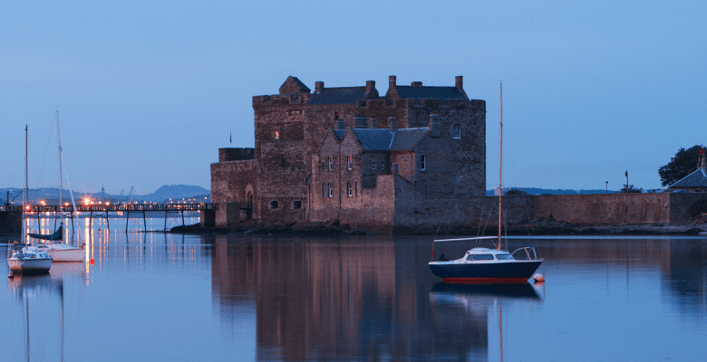 Castle sitting near the water in Edinburgh Scotland area