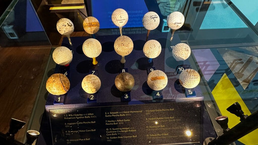 a display of different golf balls used throughout history