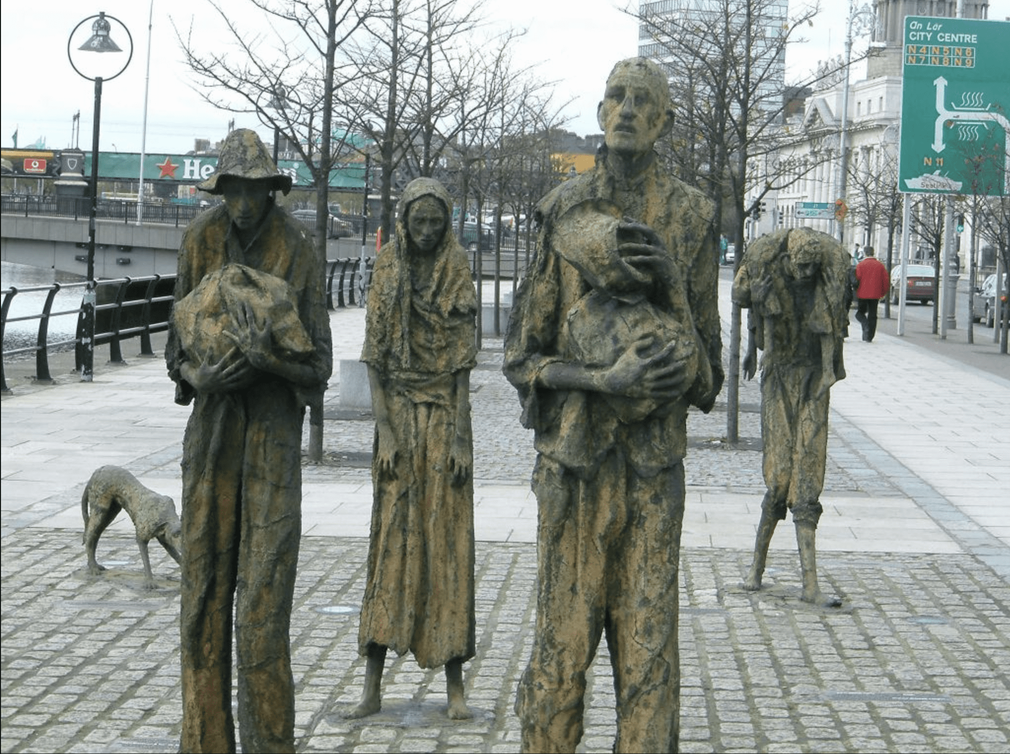 Statues and people along the river in Dublin as memorial to the famine