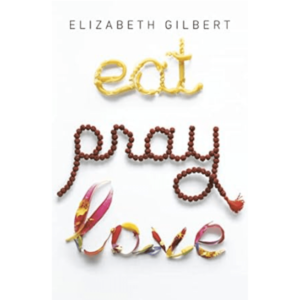 A book with a white cover with the words eat written in pasta, a word pray written in beads, and the word love written in flowers