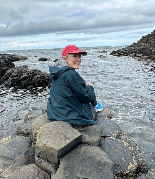 bev sitting on rocks at giant's causeway in northern ireland